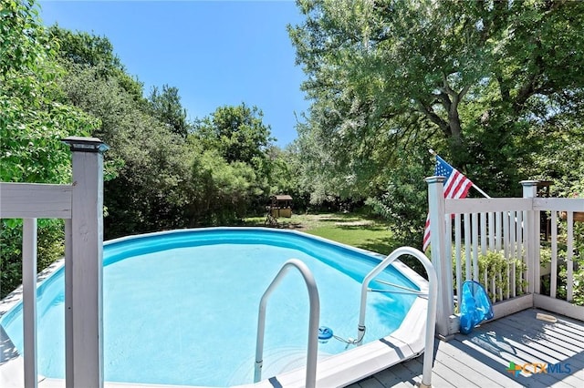 outdoor pool with view of wooded area
