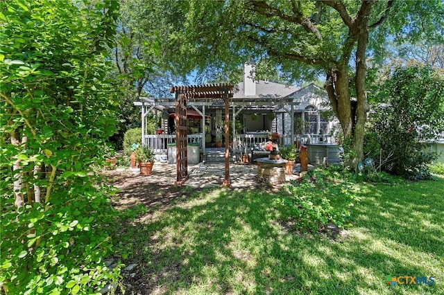 view of grassy yard with a pergola and a patio