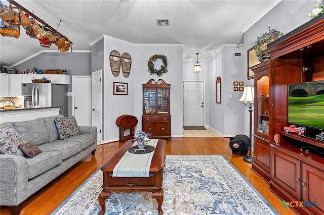 living room with crown molding, sink, and light wood-type flooring