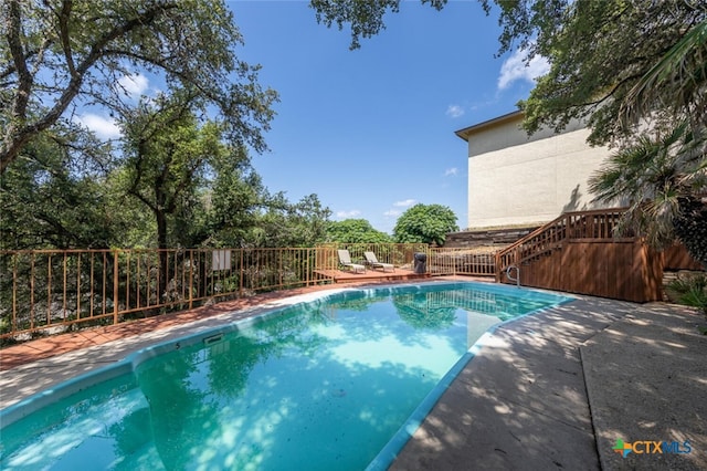 view of swimming pool with a patio area