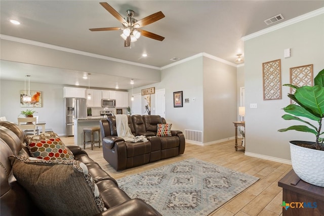 living room with light wood-type flooring, ceiling fan, and crown molding