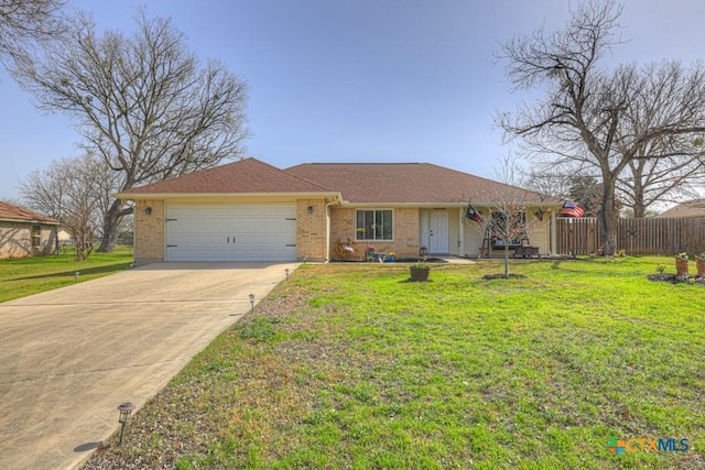 ranch-style house with an attached garage, brick siding, fence, driveway, and a front yard