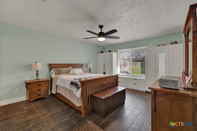 bedroom with a textured ceiling, ceiling fan, baseboards, and wood tiled floor