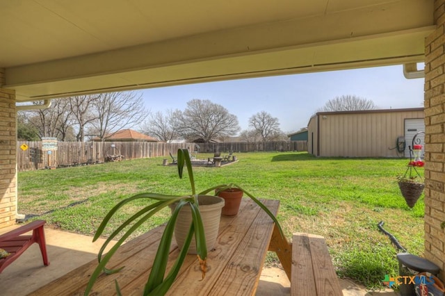 view of yard with a fenced backyard and an outbuilding