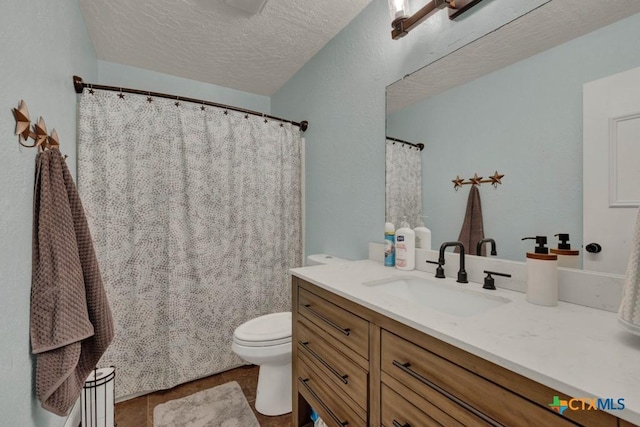 bathroom with toilet, a textured ceiling, and vanity