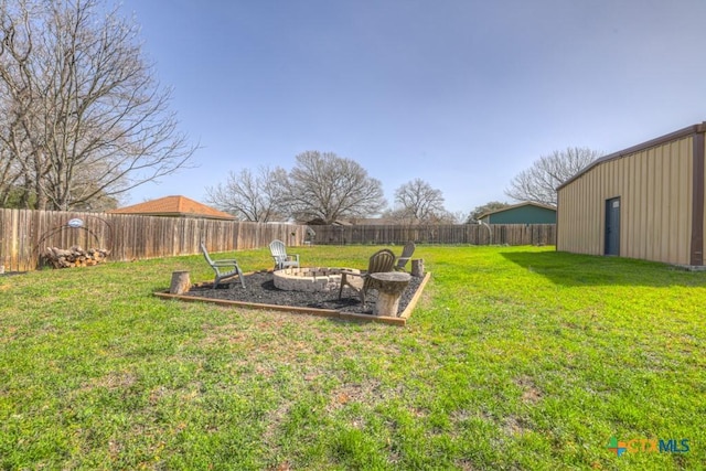 view of yard featuring an outdoor fire pit and a fenced backyard