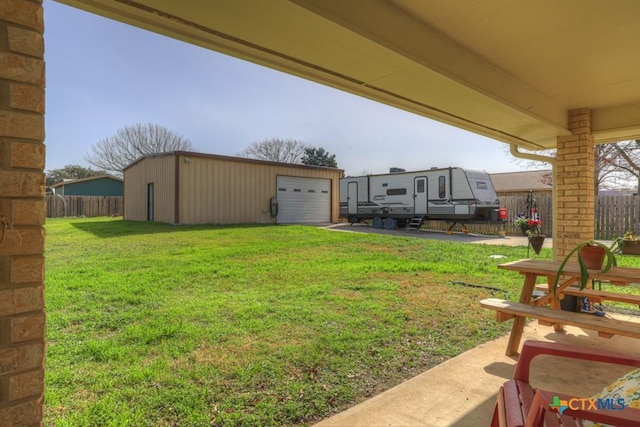 view of yard featuring an outbuilding and fence