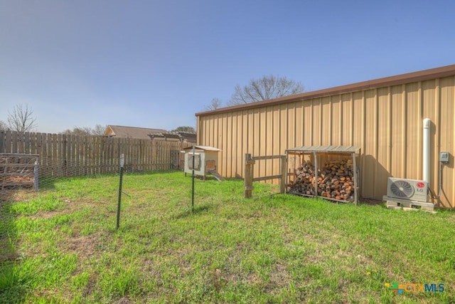 view of yard with ac unit, an outbuilding, an outdoor structure, and fence