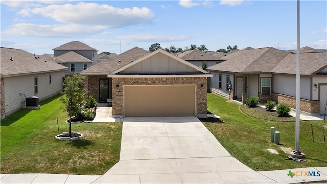 view of front of property with cooling unit, a garage, and a front yard