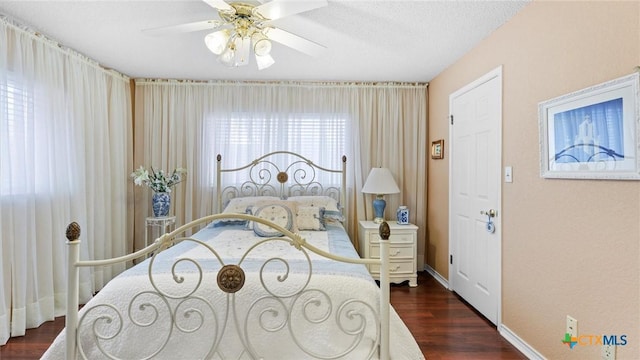 bedroom with dark wood finished floors, baseboards, and ceiling fan