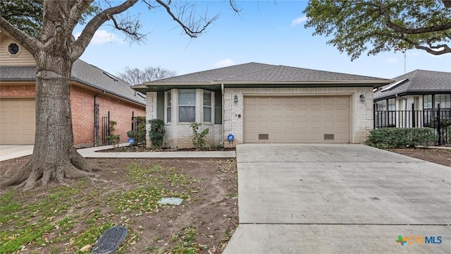 view of front facade featuring brick siding, driveway, a garage, and fence