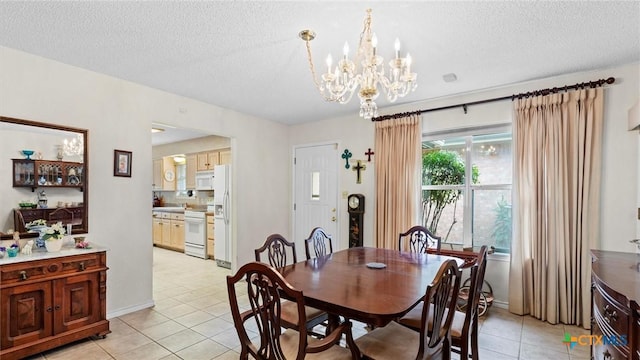 dining room with an inviting chandelier, light tile patterned flooring, baseboards, and a textured ceiling