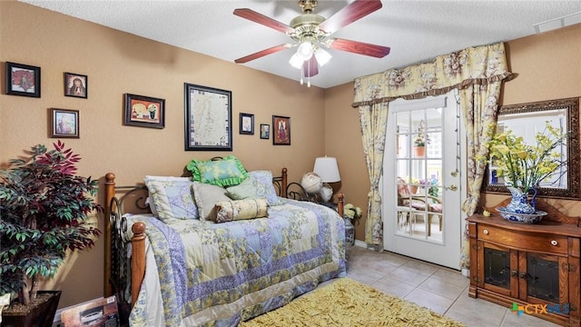 bedroom with visible vents, access to outside, a textured ceiling, light tile patterned floors, and ceiling fan