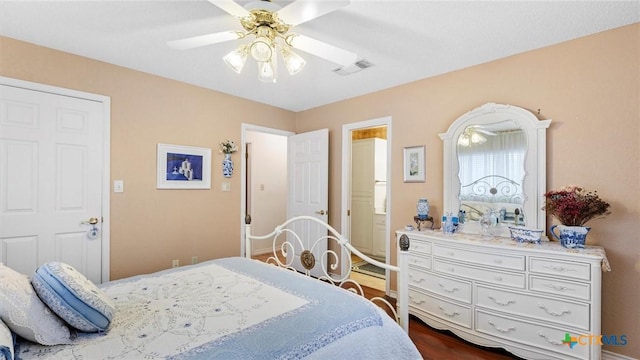 bedroom with a ceiling fan, visible vents, and dark wood-style flooring