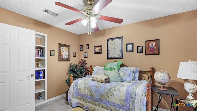 bedroom with a ceiling fan, light tile patterned floors, baseboards, and visible vents