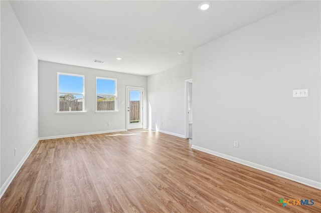 spare room with light hardwood / wood-style floors