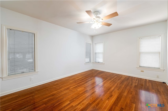 unfurnished room with ceiling fan and dark hardwood / wood-style floors