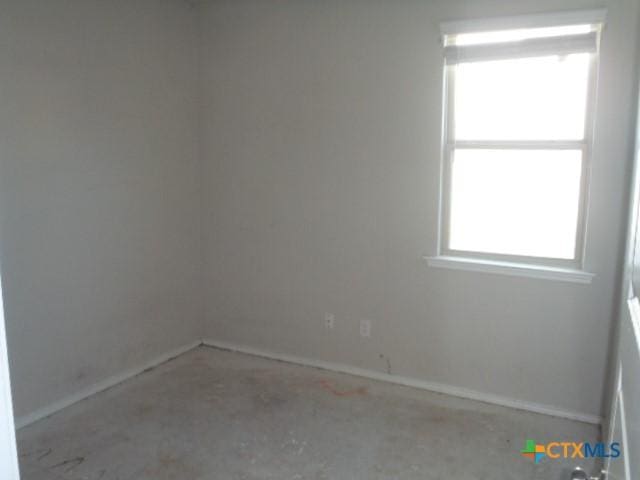 spare room with concrete flooring