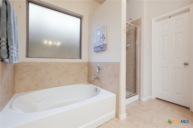 bathroom featuring separate shower and tub and tile patterned flooring