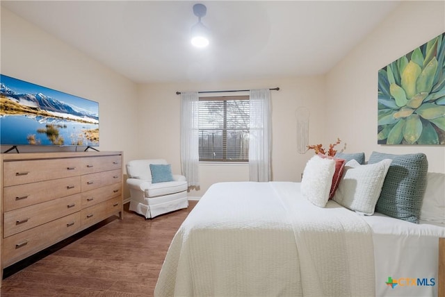 bedroom with dark wood-type flooring