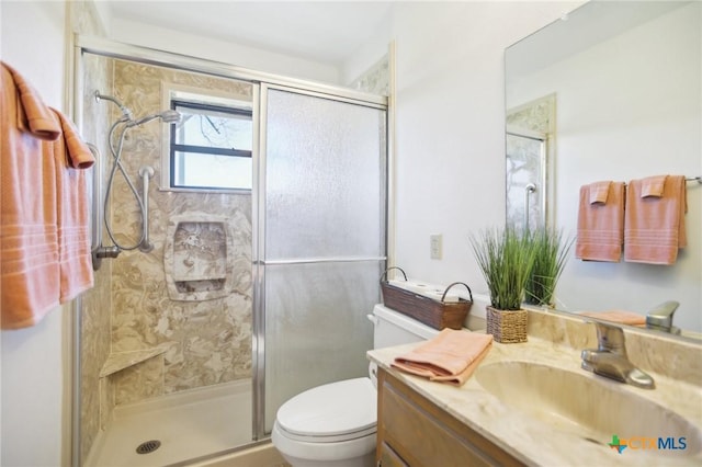 full bath with a shower stall, toilet, and vanity