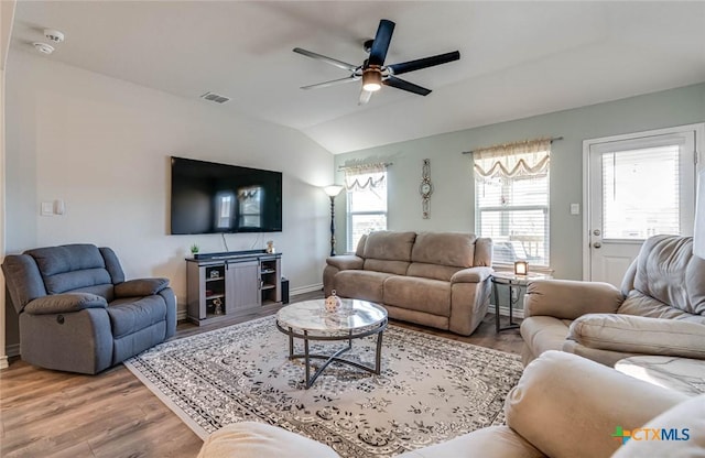 living room with hardwood / wood-style flooring, vaulted ceiling, and ceiling fan