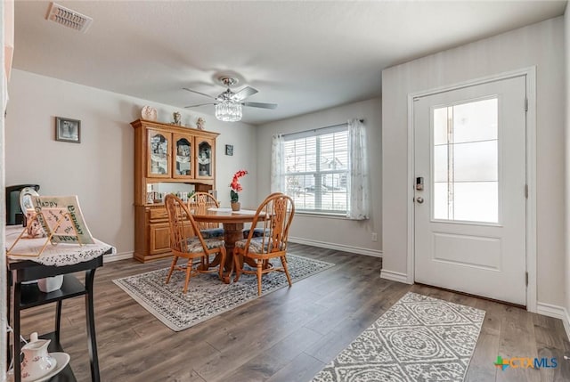 dining space featuring dark wood-type flooring and ceiling fan