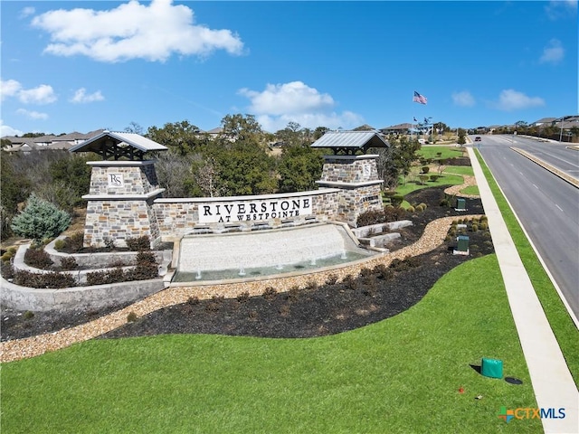 community sign featuring a yard