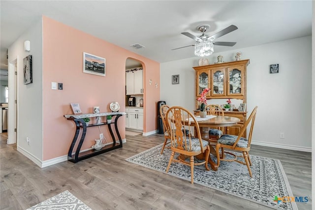 dining area with ceiling fan and light hardwood / wood-style floors