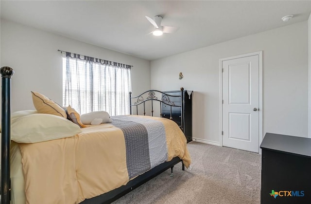 bedroom featuring ceiling fan and carpet