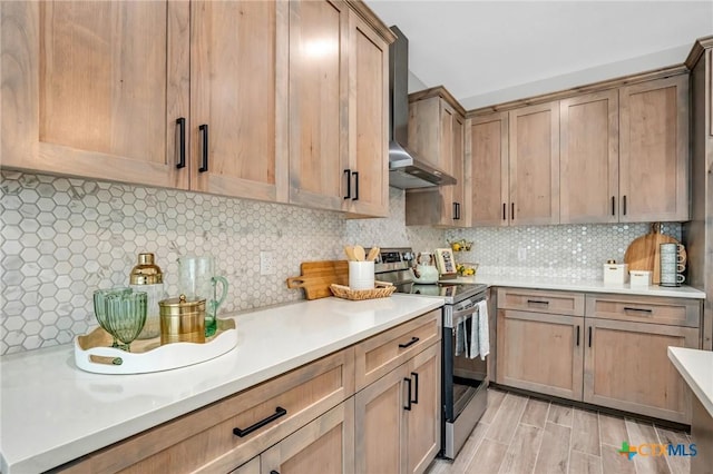 540 River Run Unit 315, New Braunfels, TX 78132 - kitchen with stainless steel range with electric stovetop, wall chimney exhaust hood, light countertops, and tasteful backsplash