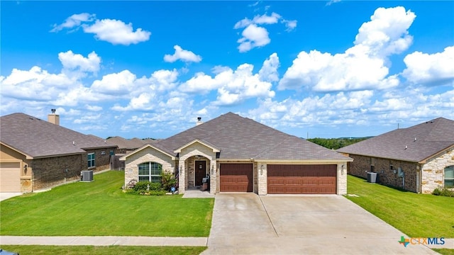 1211 Liberation Ln, Copperas Cove, TX 76522 - view of front facade featuring a garage, a front lawn, concrete driveway, and stone siding