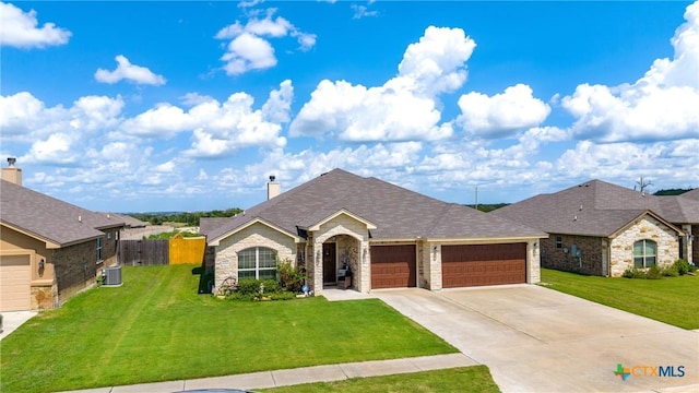 1211 Liberation Ln, Copperas Cove, TX 76522 - view of front facade with stone siding, an attached garage, concrete driveway, and a chimney