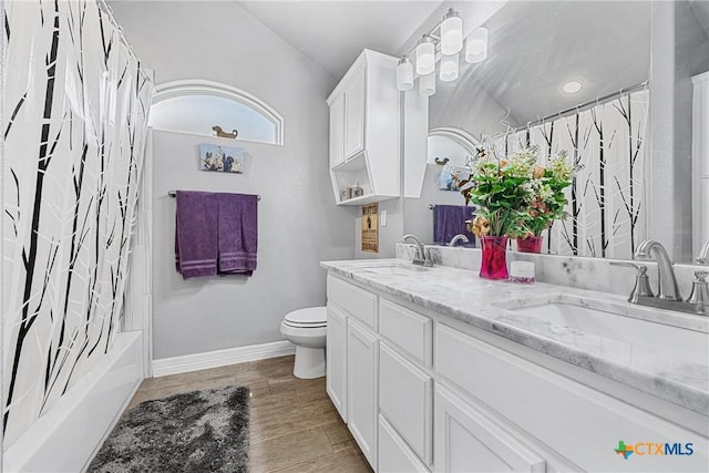 1211 Liberation Ln, Copperas Cove, TX 76522 - full bathroom featuring double vanity, lofted ceiling, wood finished floors, and shower / bath combination with curtain