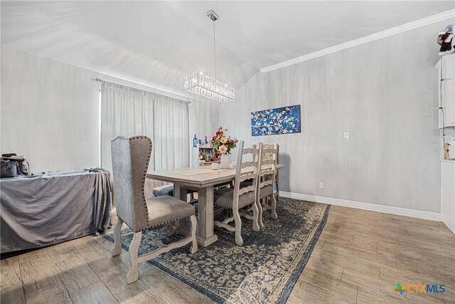 1211 Liberation Ln, Copperas Cove, TX 76522 - dining room with a chandelier, vaulted ceiling, crown molding, and wood finished floors