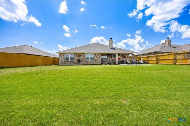 1211 Liberation Ln, Copperas Cove, TX 76522 - back of house featuring a fenced backyard, a patio, and a chimney