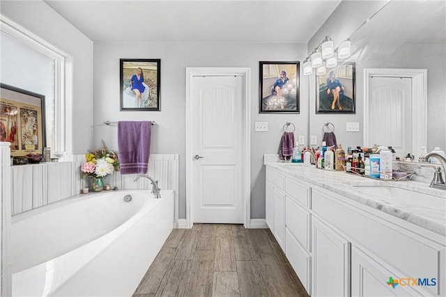 1211 Liberation Ln, Copperas Cove, TX 76522 - full bath featuring double vanity, wood finished floors, and a garden tub