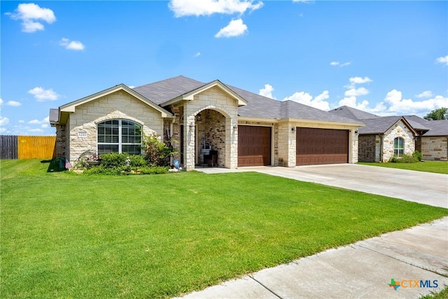 1211 Liberation Ln, Copperas Cove, TX 76522 - ranch-style home featuring a garage, stone siding, and concrete driveway