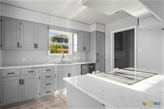 kitchen with dishwasher, gray cabinets, light hardwood / wood-style floors, and sink