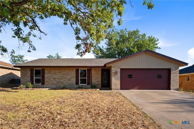 ranch-style home with a garage and a front yard