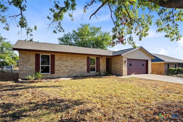 ranch-style home with a garage and a front yard