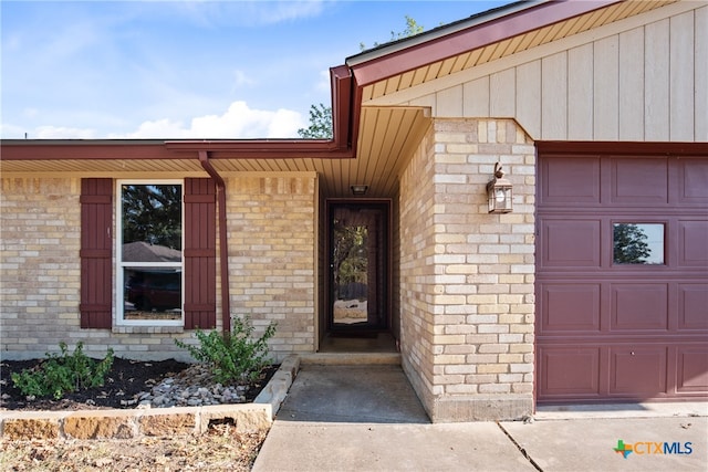 view of exterior entry with a garage