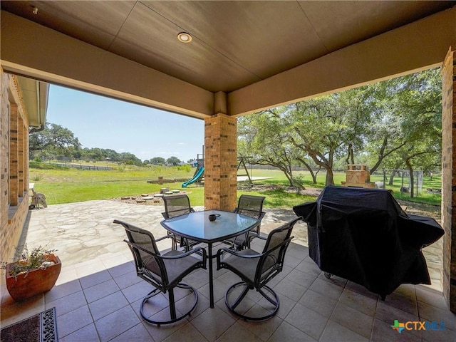view of patio / terrace featuring outdoor dining area and a grill