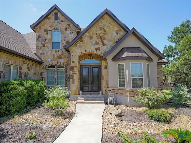 view of front of home with stone siding and french doors