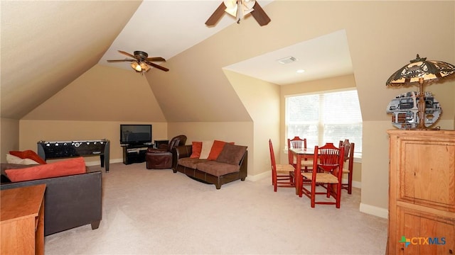 living room featuring ceiling fan, vaulted ceiling, light carpet, and baseboards