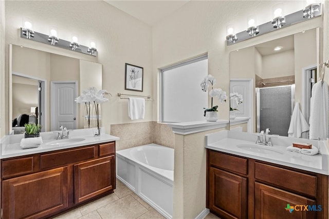 834 Wall St, New Braunfels, TX 78130 - bathroom featuring a stall shower, a bath, two vanities, and tile patterned floors