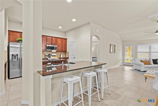 834 Wall St, New Braunfels, TX 78130 - kitchen with stainless steel appliances, arched walkways, ceiling fan, open floor plan, and a sink