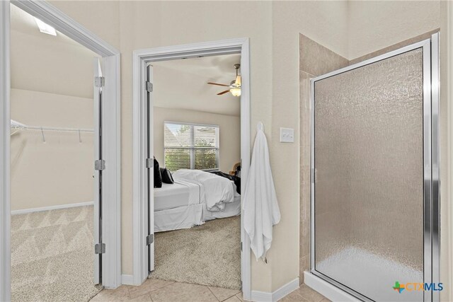834 Wall St, New Braunfels, TX 78130 - ensuite bathroom with a shower stall, a spacious closet, ceiling fan, and tile patterned flooring