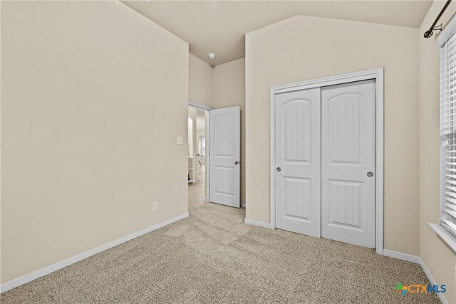834 Wall St, New Braunfels, TX 78130 - unfurnished bedroom with carpet floors, baseboards, vaulted ceiling, and a closet