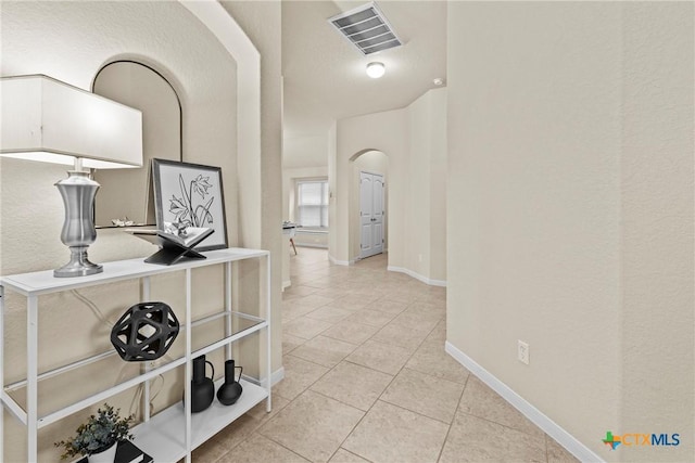 834 Wall St, New Braunfels, TX 78130 - hall featuring arched walkways, light tile patterned flooring, and baseboards